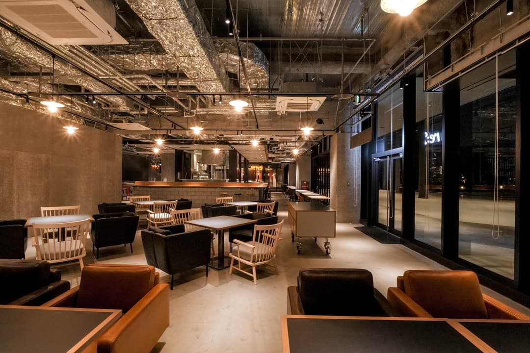 シェア型フードホールの共通席エリア - 複数店舗のメニューを横断注文できる客席